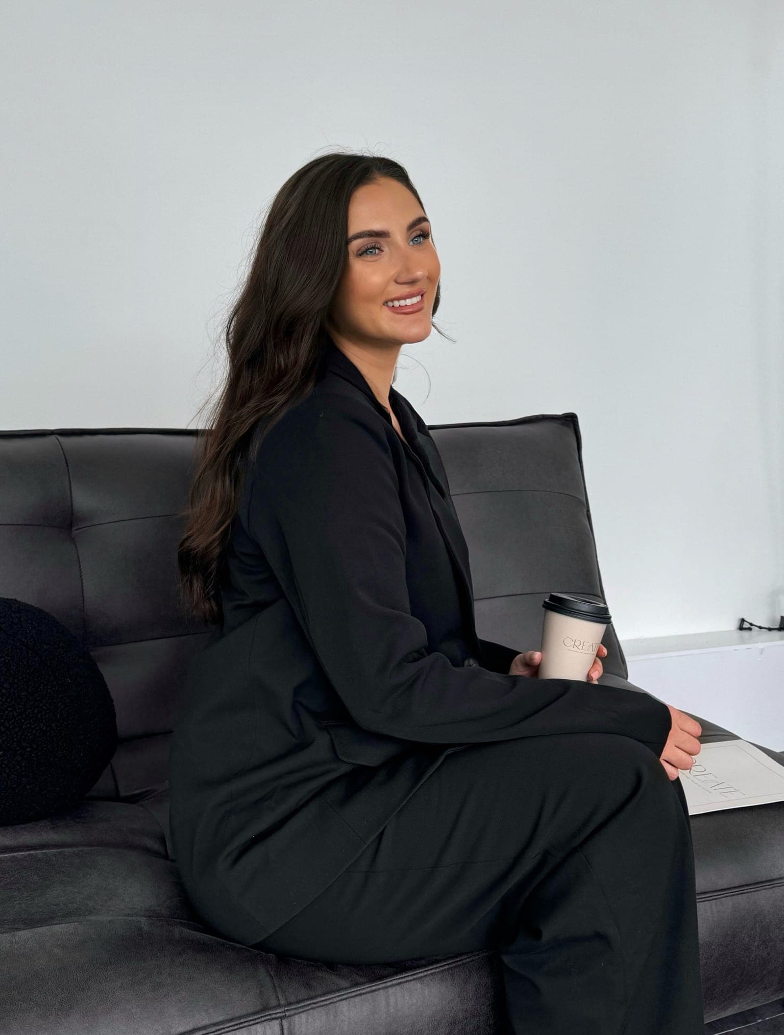 Aimee Stokes, CREATE founder and educator, relaxing with a CREATE coffee cup