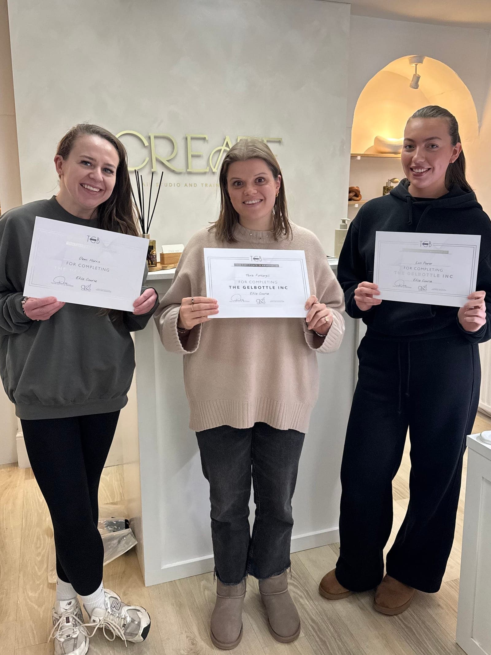 Three CREATE students with their e-file course certificates in the studio